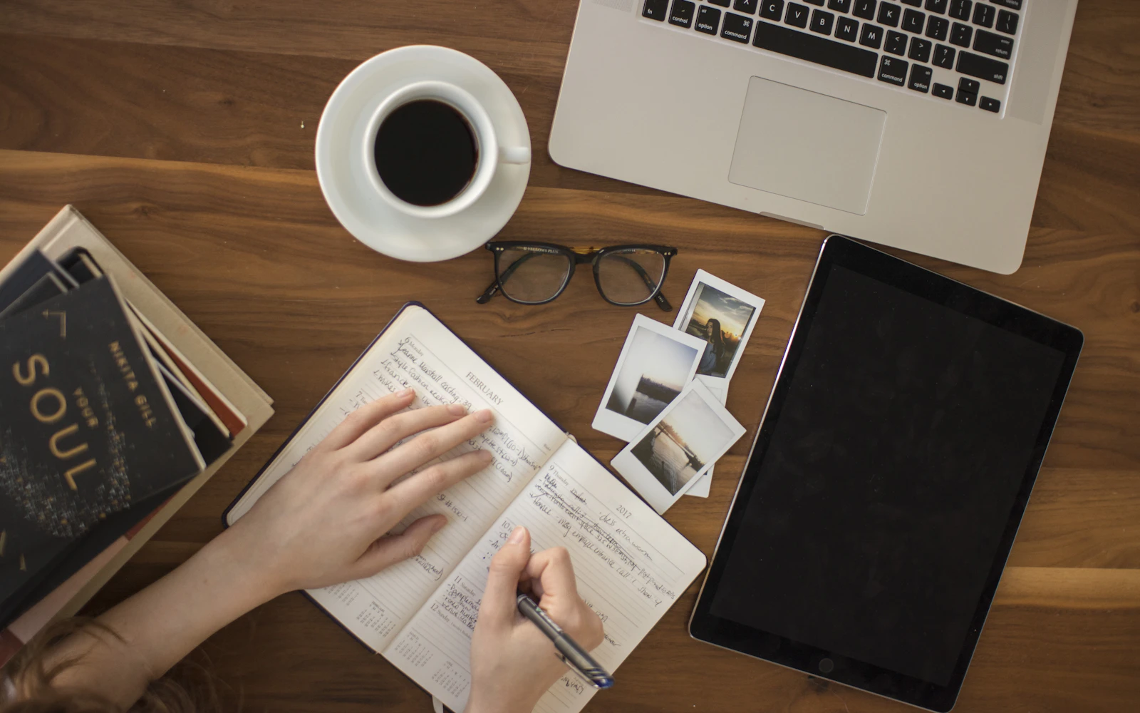 Author writing at a desk, the person behind good author website design