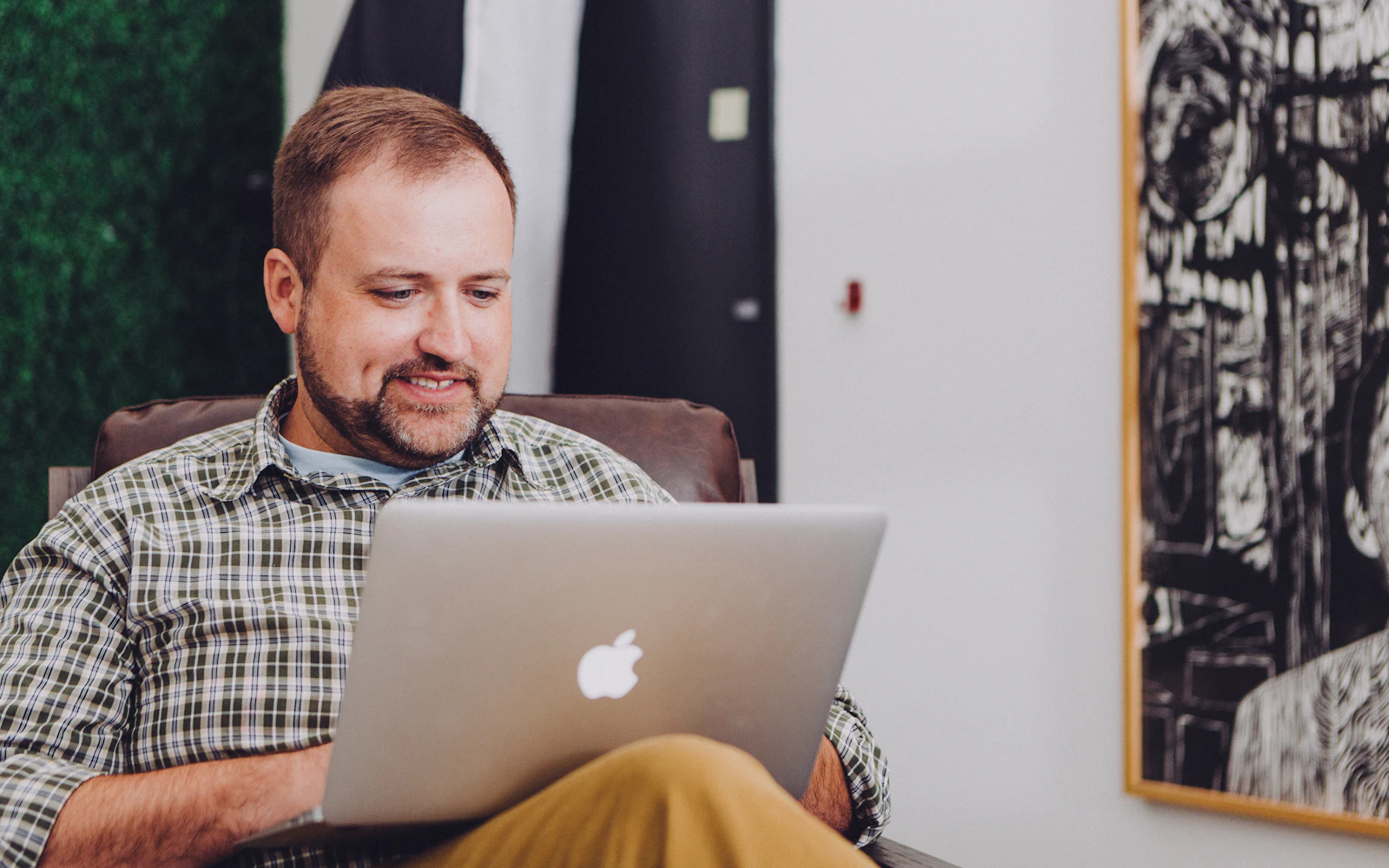 Small business owner checking a website on a laptop at a desk