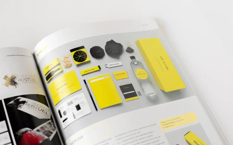 Printed pages of a brand style guide showing logo and color rules