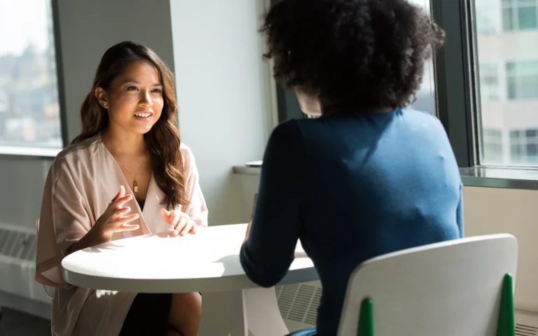 Executive coach in conversation with a client, the outcome coaching website design should lead to
