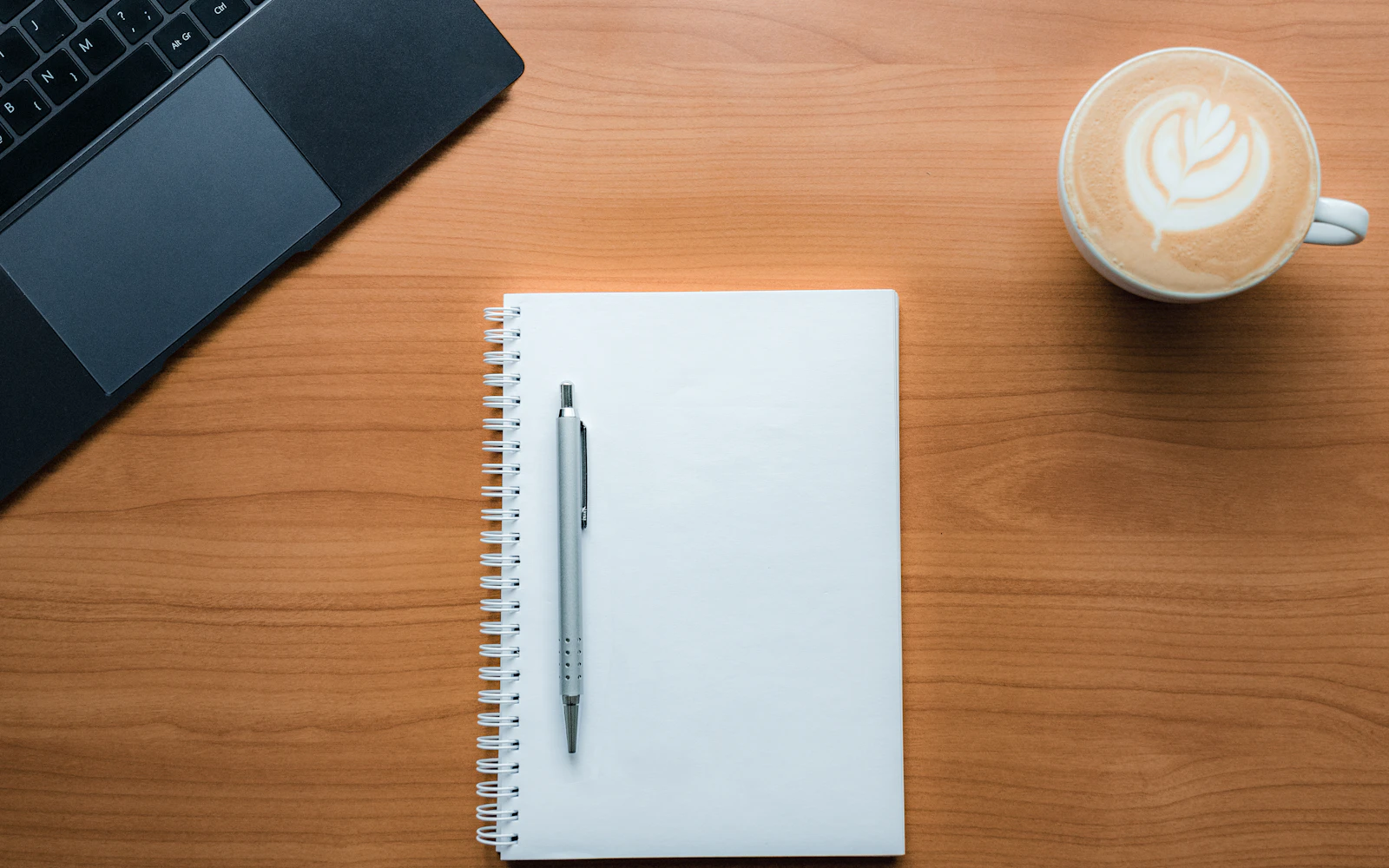 Consultant planning content marketing for consultants in a notebook with coffee