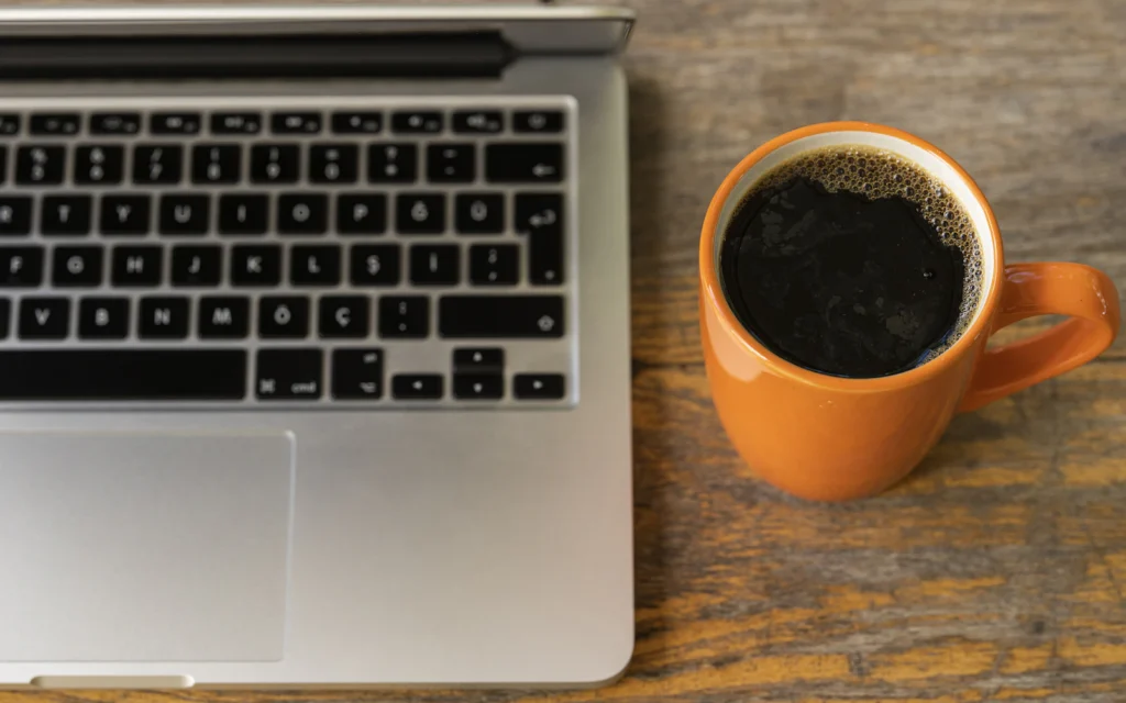 Laptop and coffee ready for writing a newsletter, part of email marketing for consultants