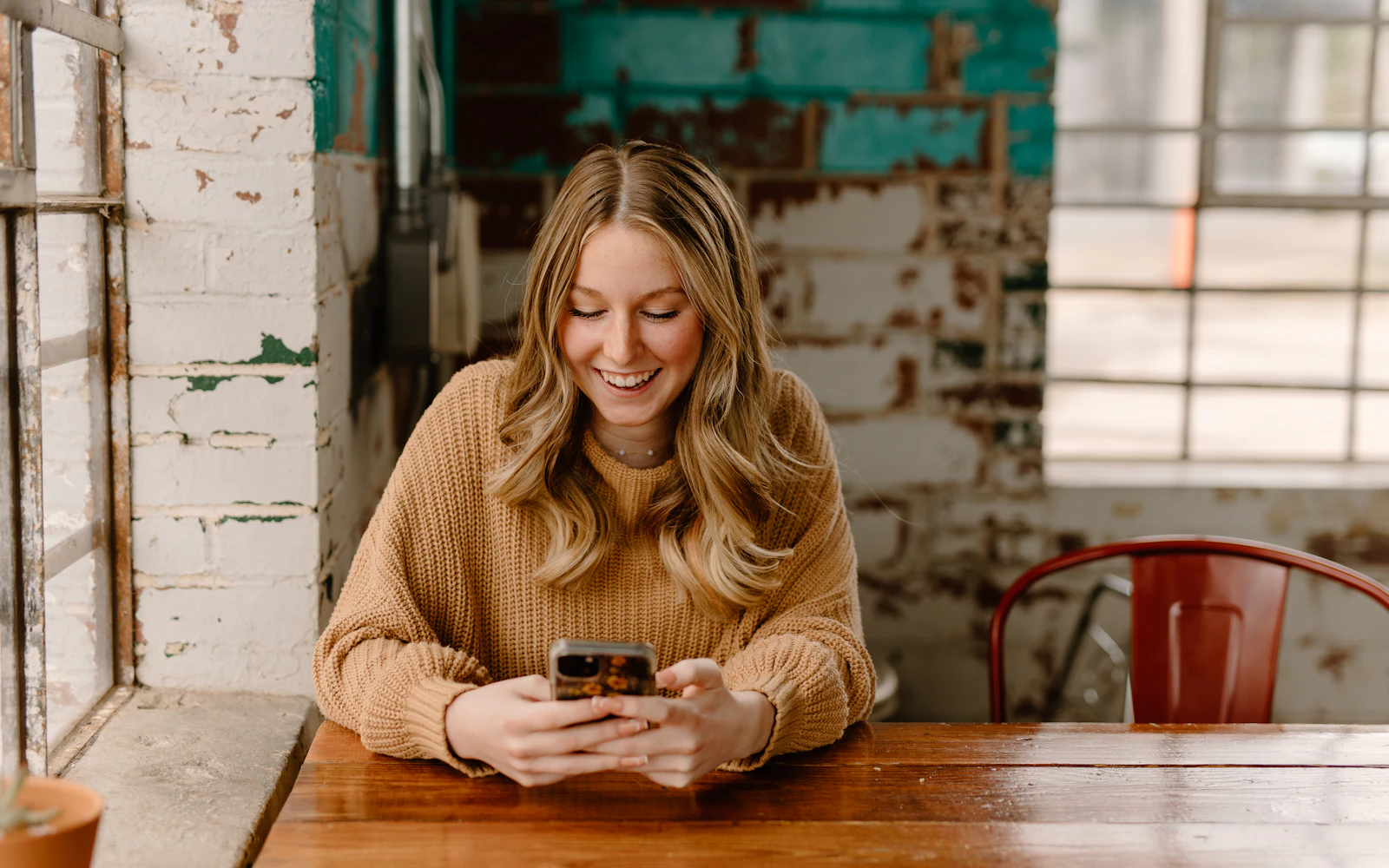 Customer reading a brand email on her phone in a cafe