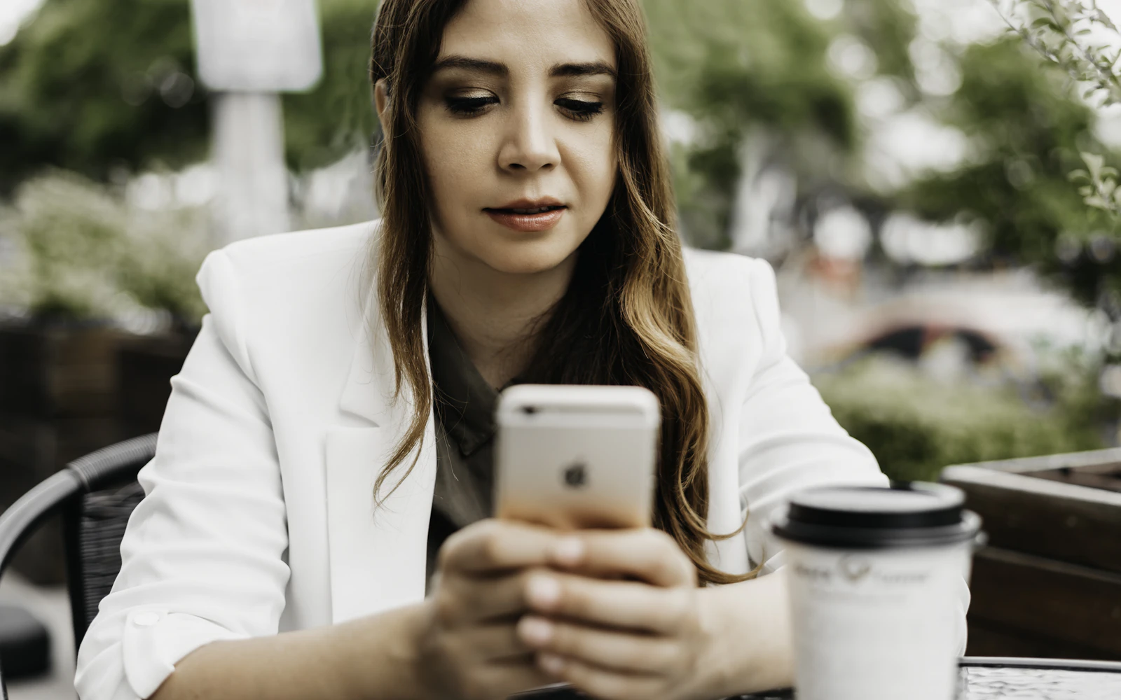 Client reading a newsletter on her phone, sent through our email marketing services