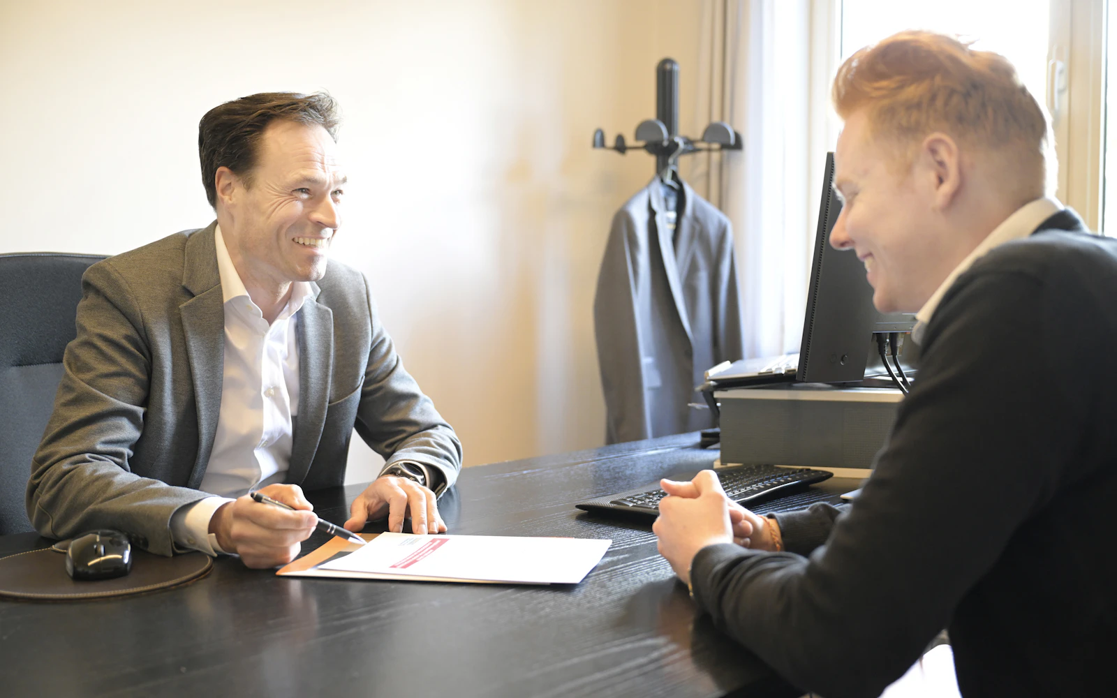 Consultant meeting a client in a small office