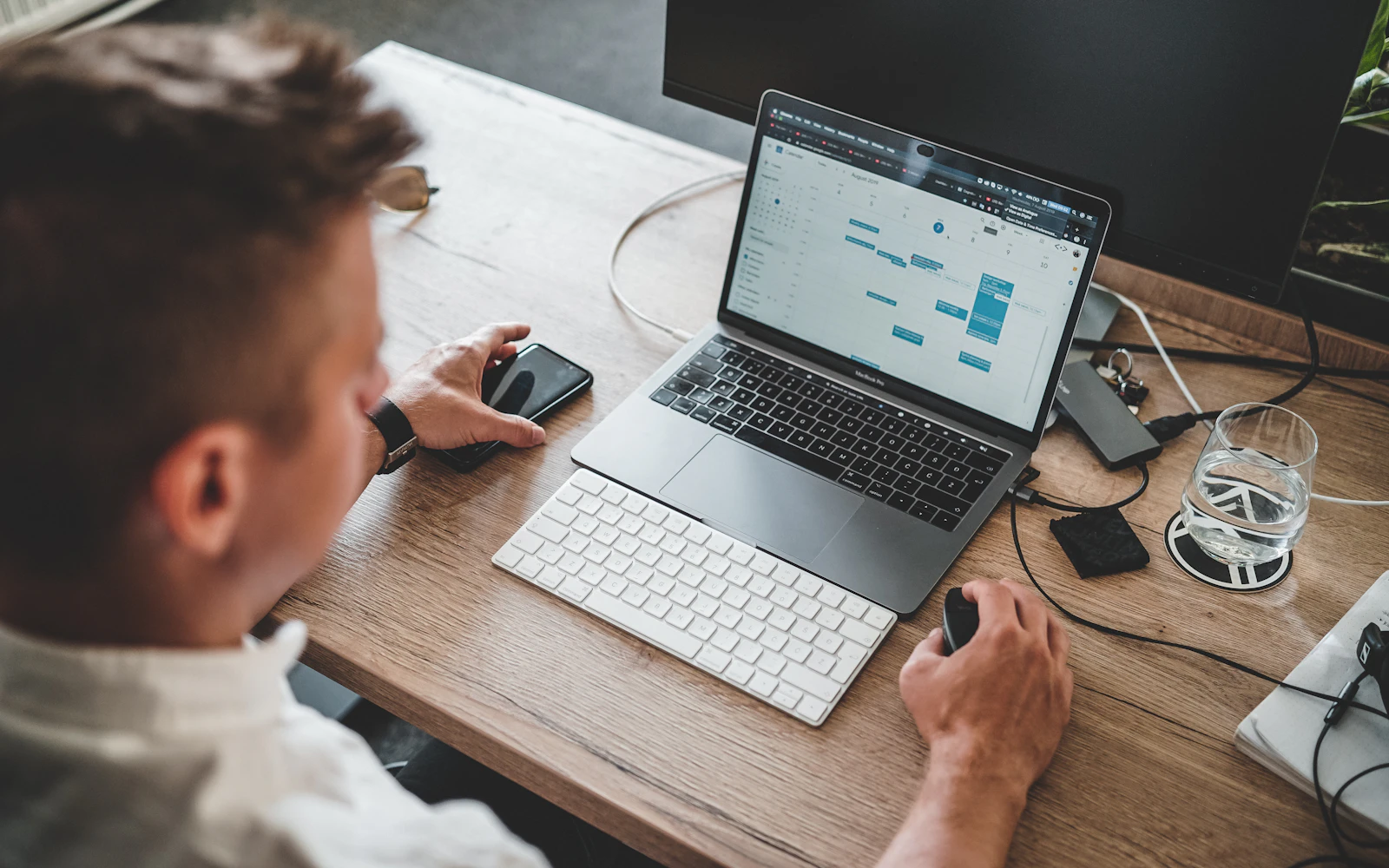 Web designer managing a client website on a laptop in an office
