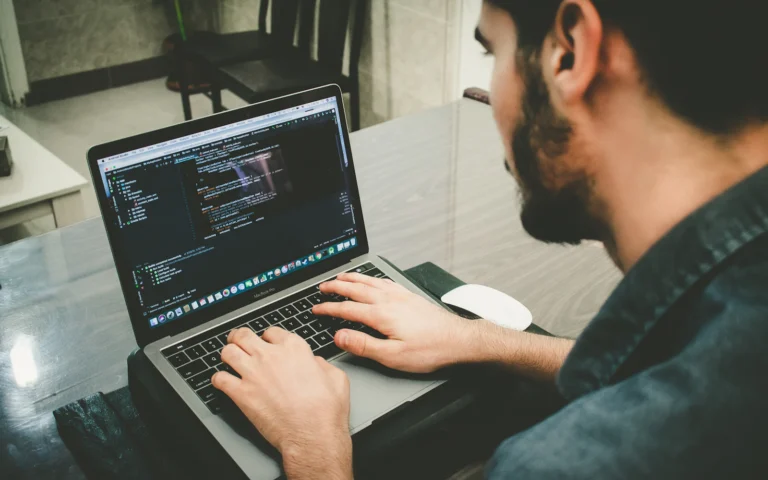 Developer working out how to migrate a WordPress site on a laptop