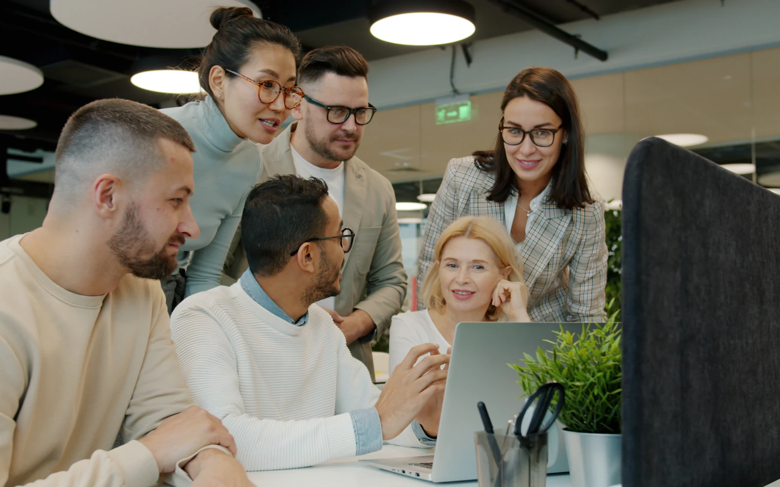 Small team checking a website on a laptop after moving it to a new host