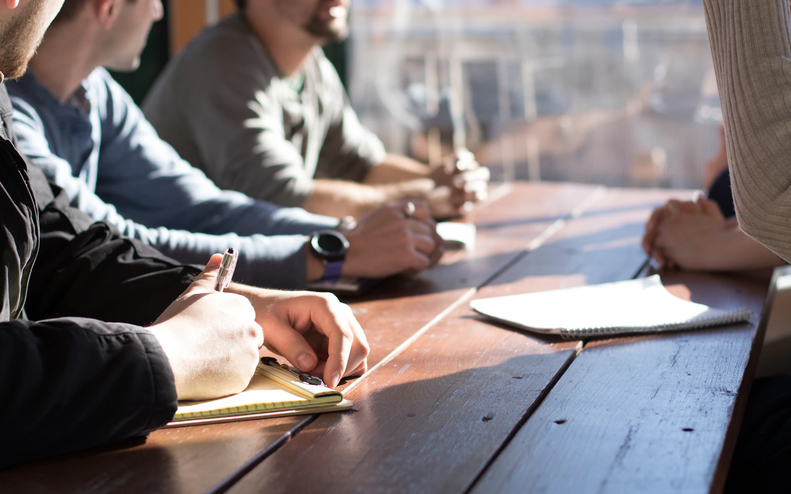 Small professional firm team meeting around a table