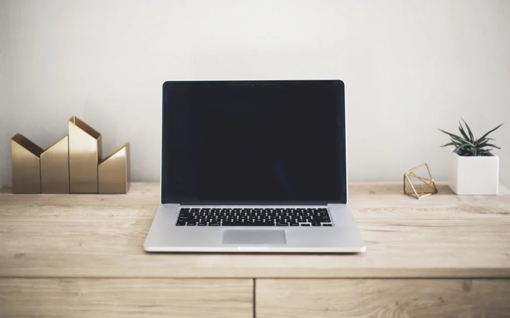 Laptop on a clean desk ready to review a landing page design