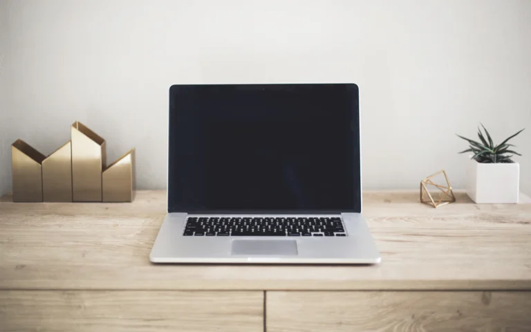 Laptop on a clean desk ready to review a landing page design