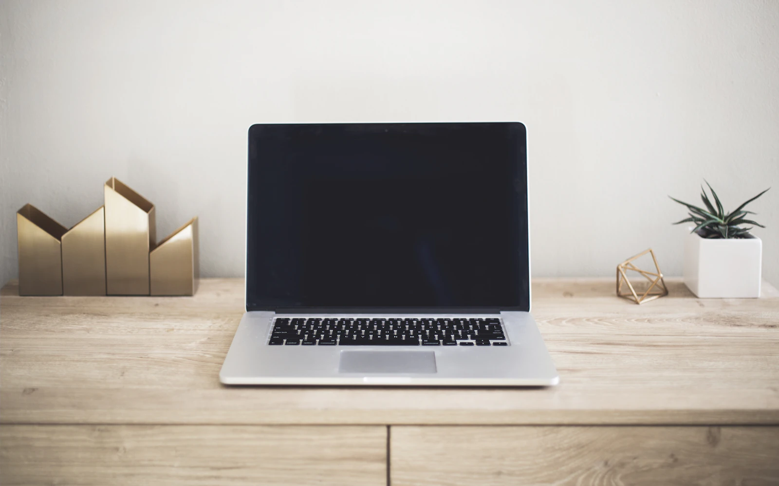 Laptop on a clean desk ready to review a landing page design