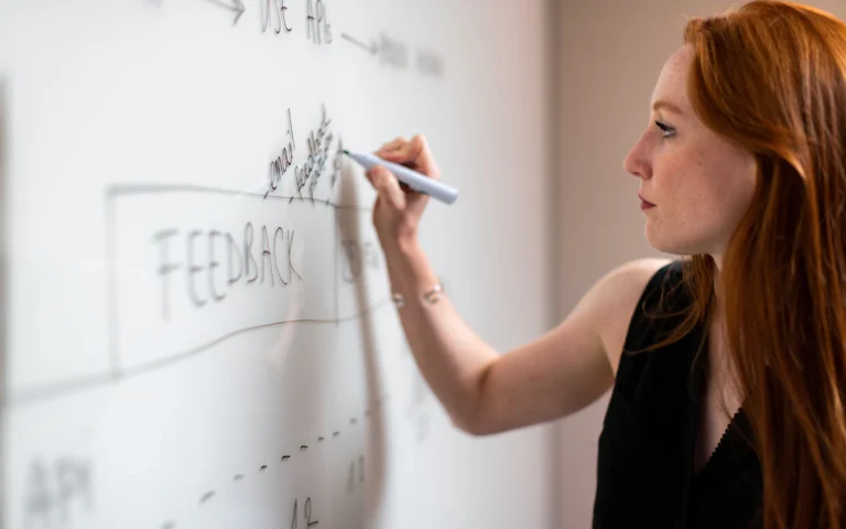 Consultant mapping out a lead generation for consultants plan on a whiteboard