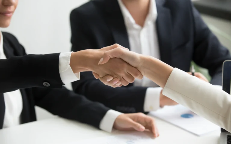 Consultants shaking hands as part of link building for small business