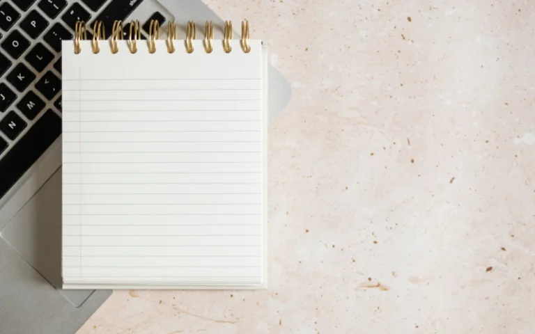 Notepad on a desk for drafting LinkedIn about section examples