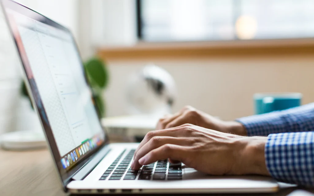 LinkedIn banner design being created on a laptop by a consultant
