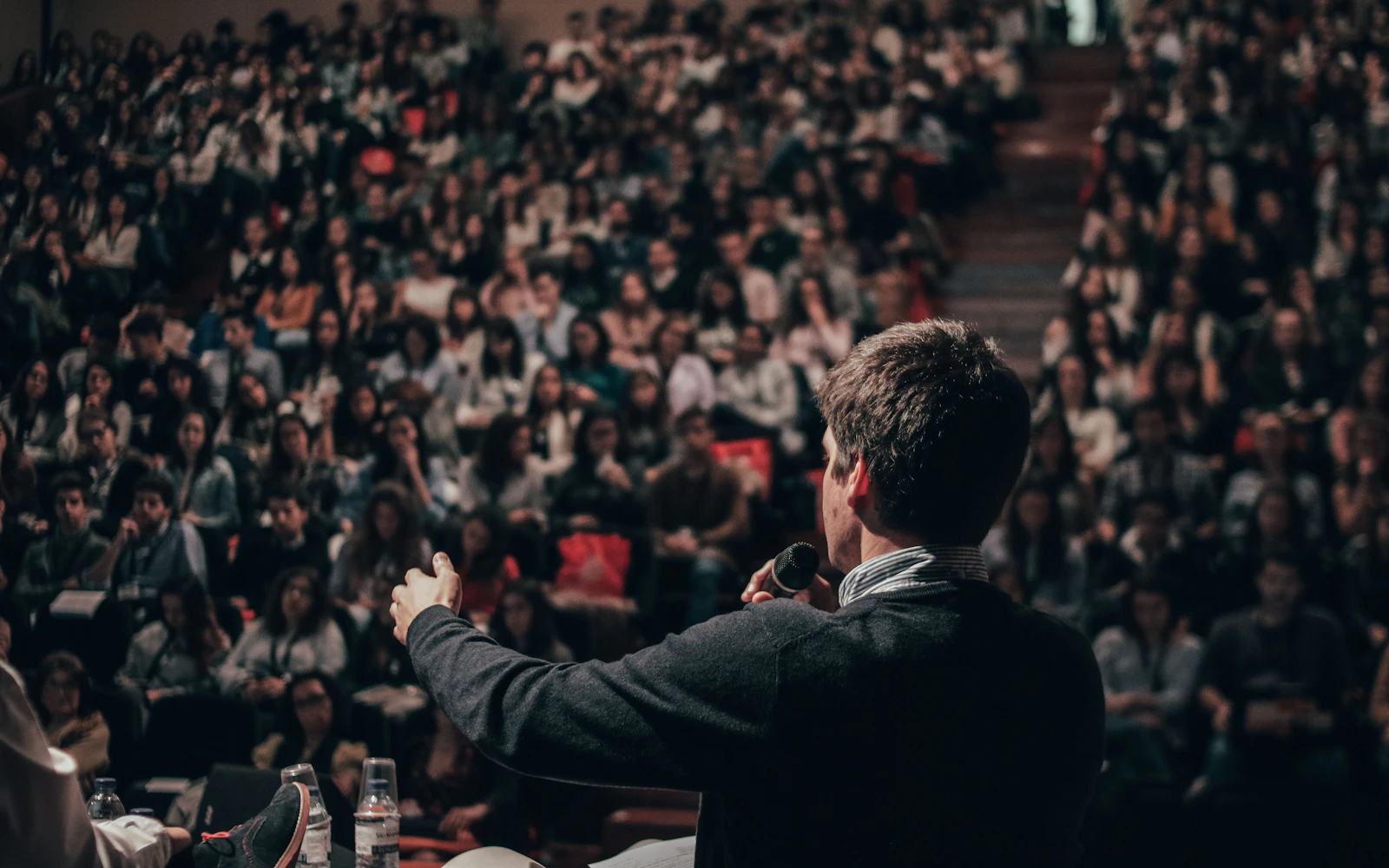 Keynote speaker on stage in front of a conference audience