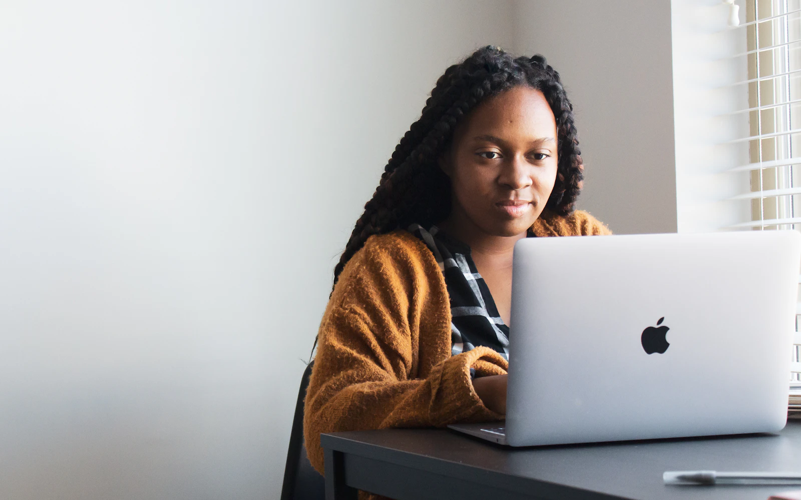 Professional reviewing a company page on LinkedIn from a laptop