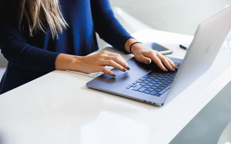 Consultant reviewing LinkedIn headline examples on a laptop