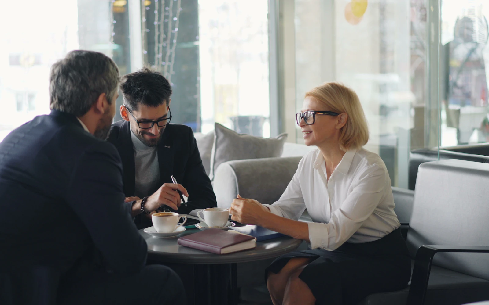 Consultant talking with a prospective client over coffee
