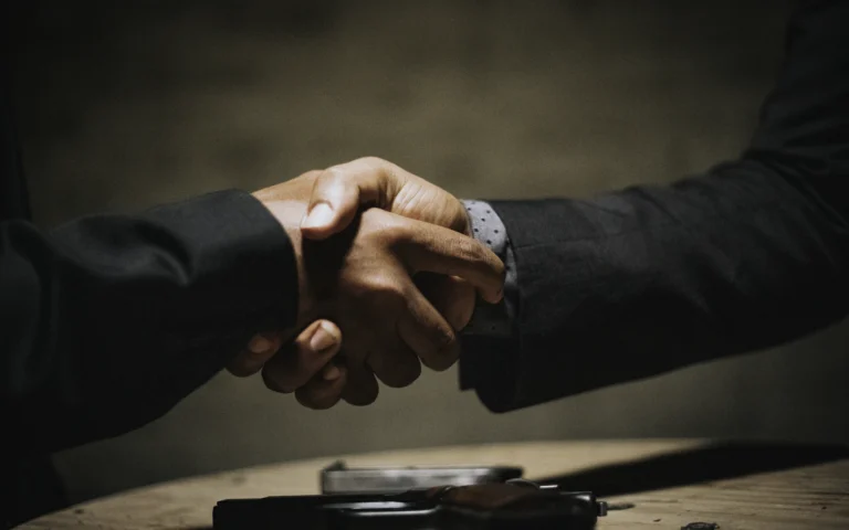 Consultant and client shaking hands after a project, the moment to ask for LinkedIn recommendations