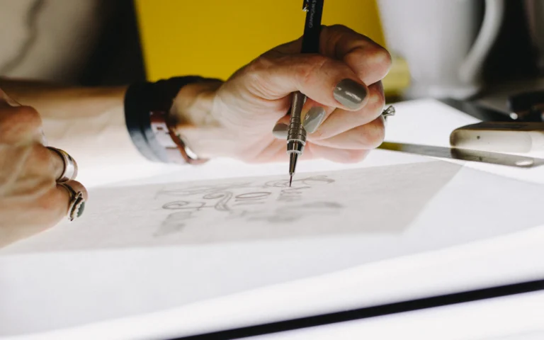 Designer sketching early concepts during logo design for consultants
