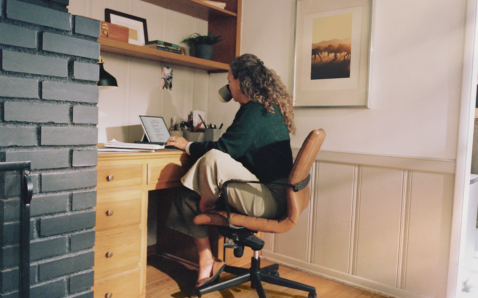 Consultant working calmly on a laptop while the website runs in the background
