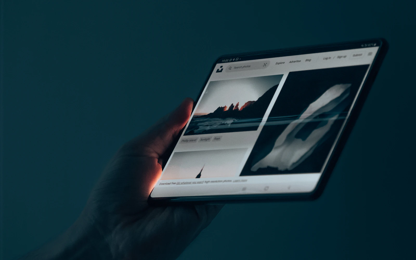 Designer testing a website on several phones and a tablet