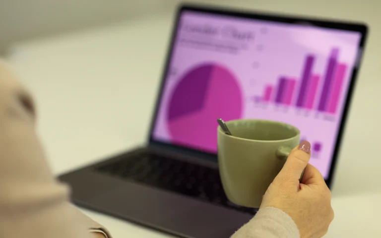 Consultant working through an on page SEO checklist on a laptop