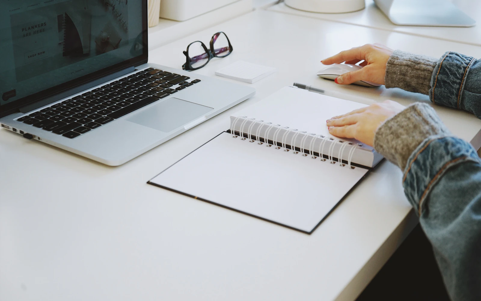 Writer editing a service page draft at a desk