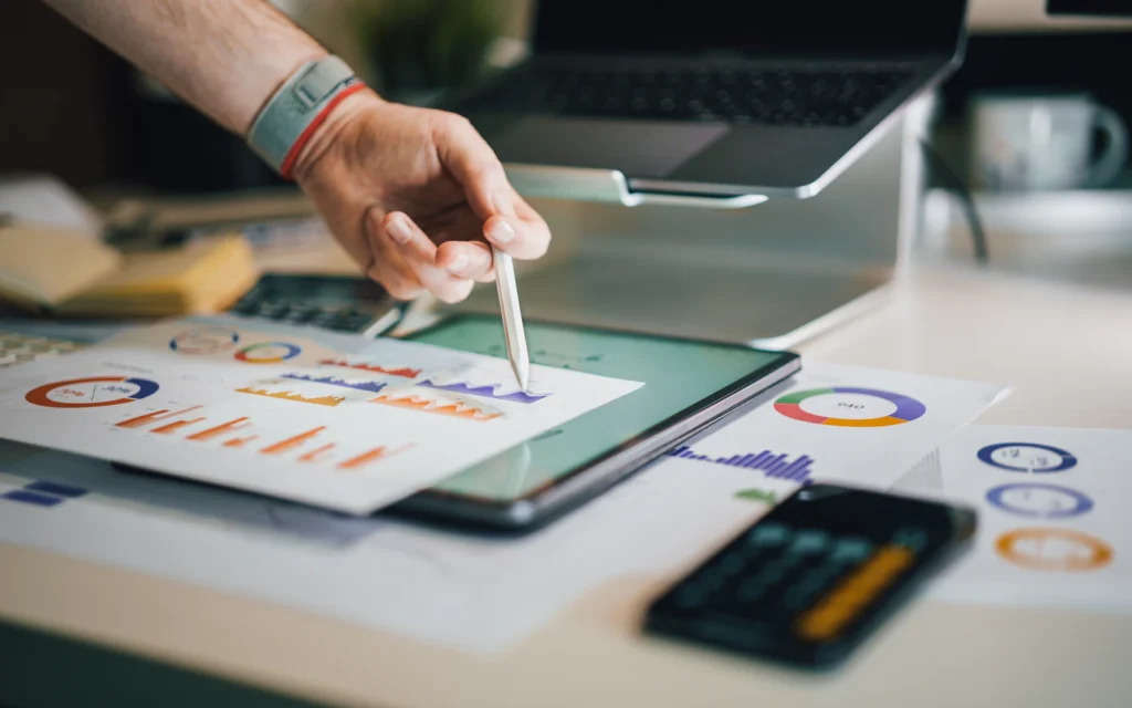 Consultant working through an SEO audit checklist with charts on a tablet