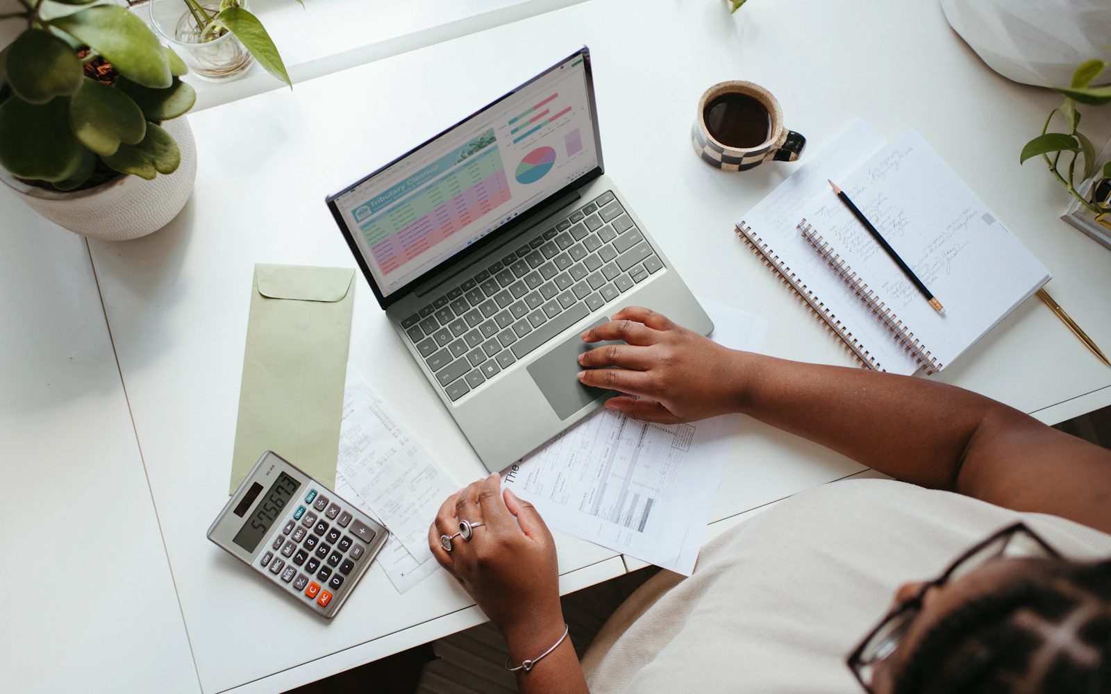 Small business owner writing a prioritized list of website fixes