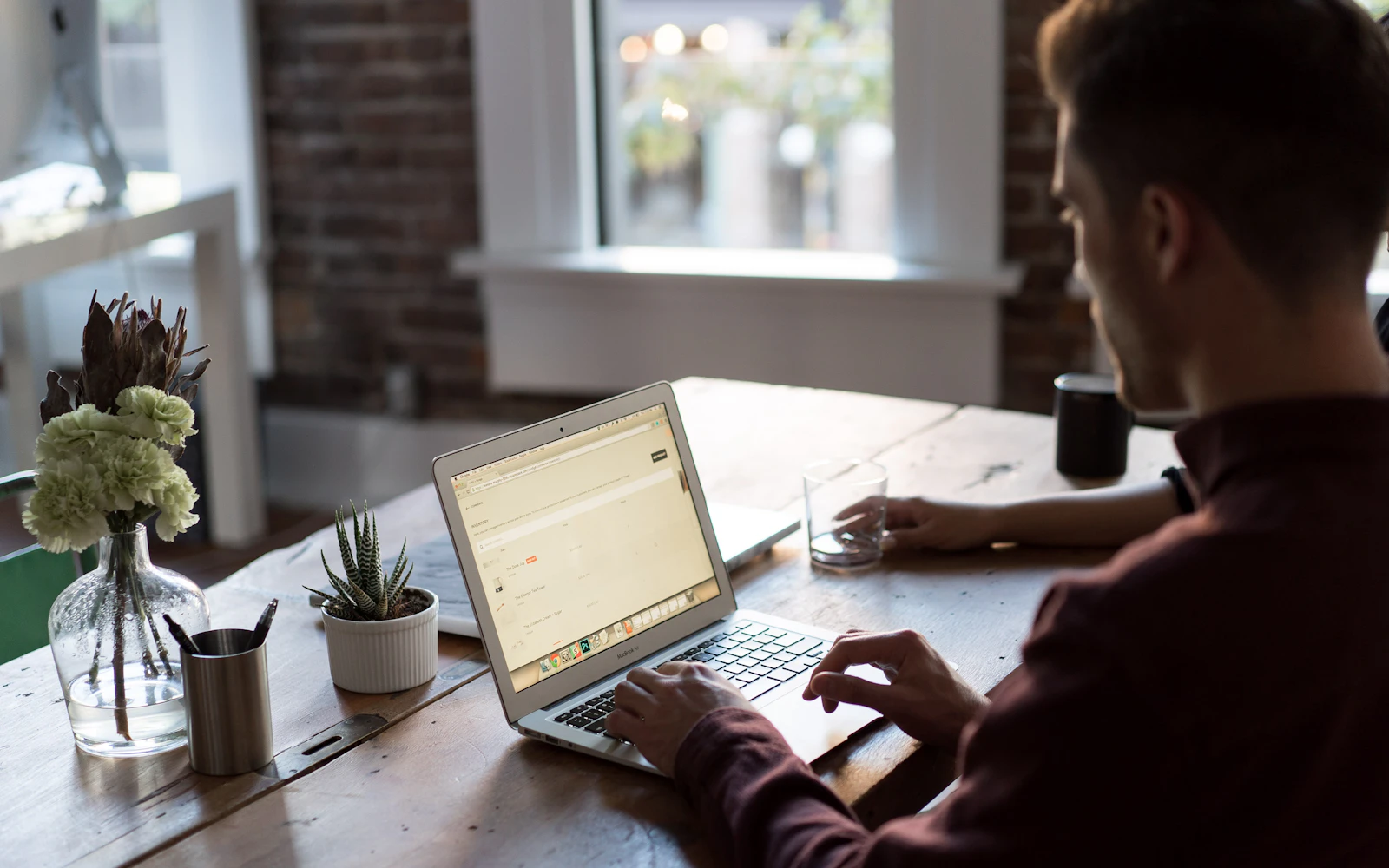 Store owner comparing Shopify vs WooCommerce on a laptop