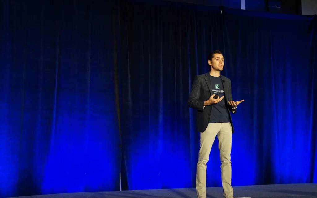 Keynote speaker on stage, the kind of footage good speaker website design puts up front