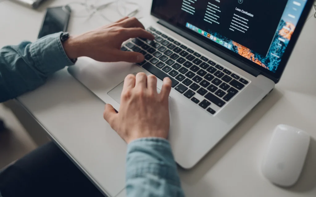 Designer adjusting Squarespace SEO settings on a laptop