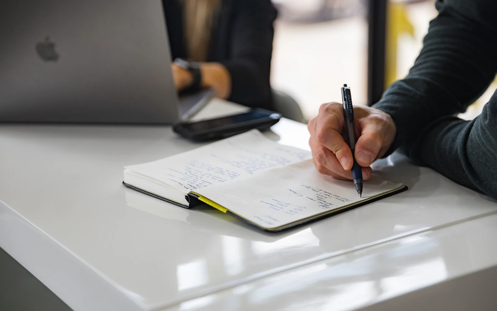 Consultant planning pages with a website content checklist at a desk