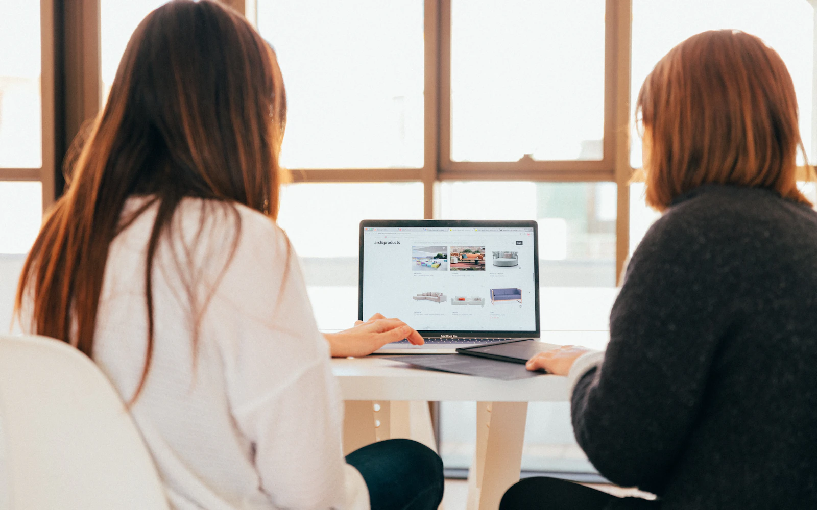 Two people reviewing a new website on a laptop before launch