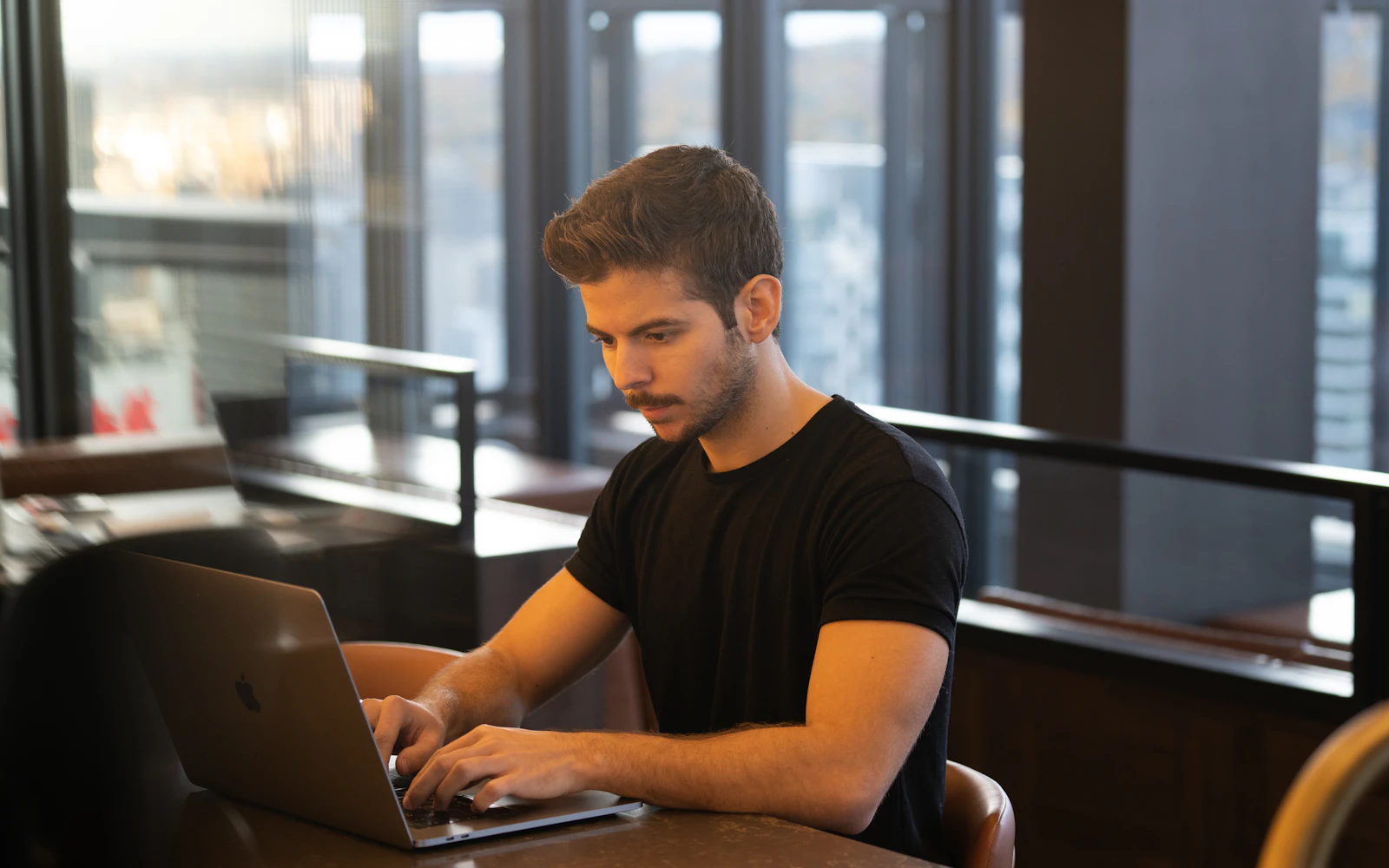 Web designer building a consultant website on a laptop