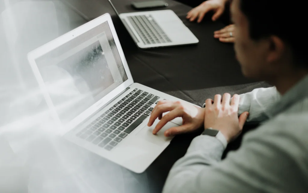 Designer reviewing a Wix website design on a laptop